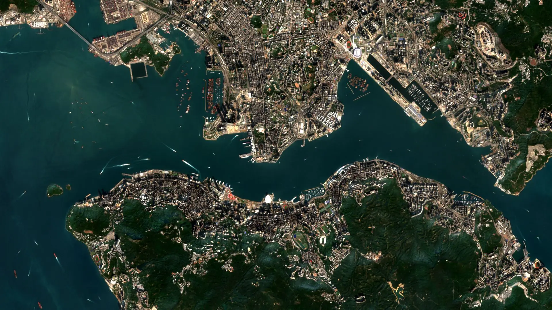 Sentinel-2 image of Victoria Harbour, with Kowloon to the north, Hong Kong Island and its wooded hills to the south, and ships at anchor in the western harbour. Victoria Harbour, Hong Kong, 13 January 2026