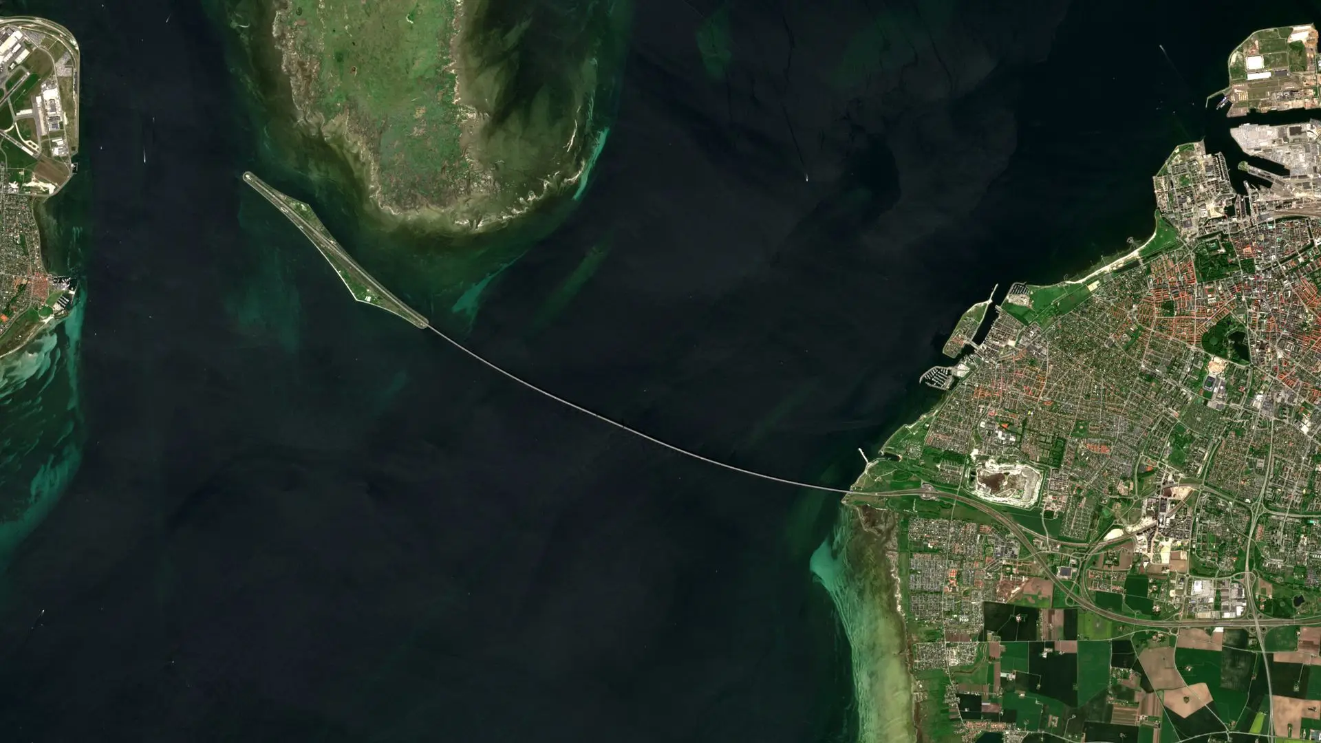 Sentinel-2 image of the Øresund Bridge running from the artificial island of Peberholm to Malmö, with the island of Saltholm to the north and the edge of Copenhagen Airport on the left. The Øresund Bridge between Denmark and Sweden, 25 May 2026