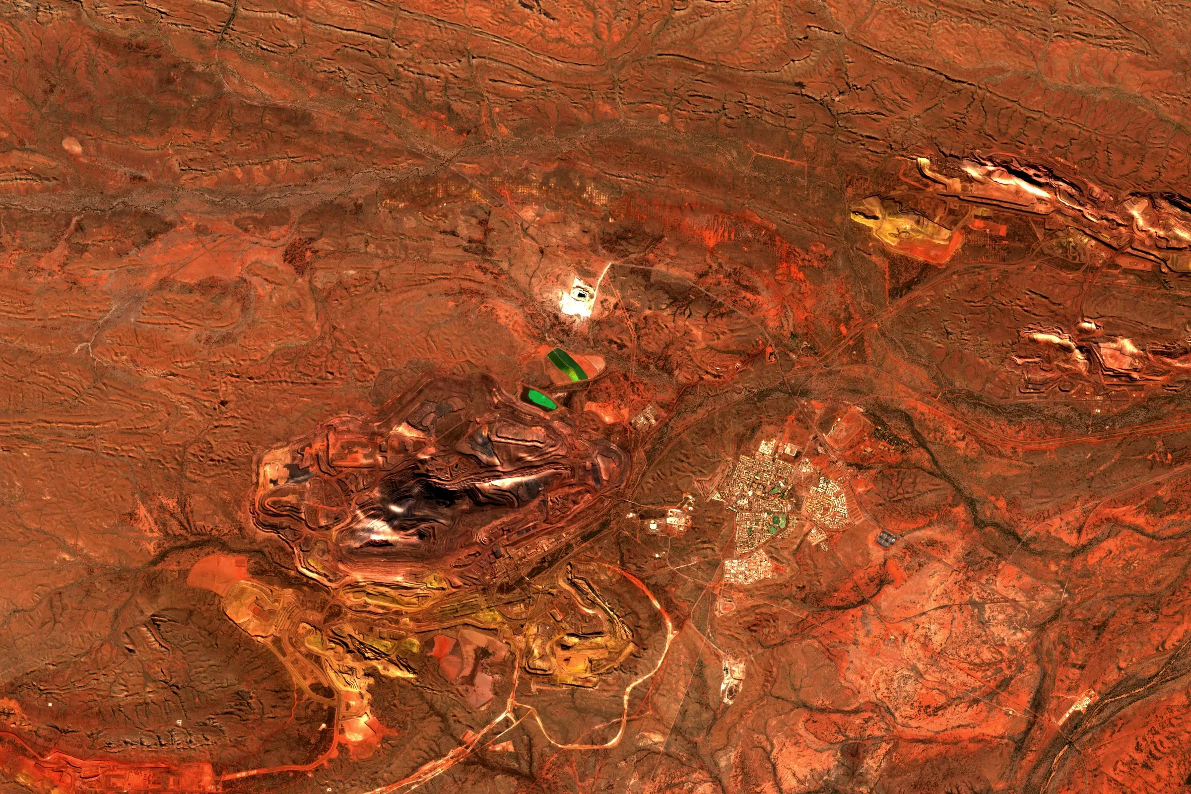 Satellite view of the Mount Whaleback iron ore mine in the red Pilbara landscape of Western Australia
